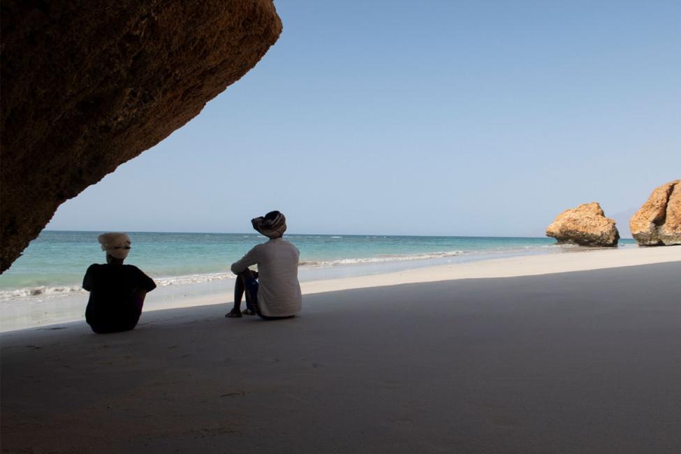 Two migrants sit by the sea in Somalia, in anticipation of the journey. Photo: IOM/Ismail Salad Osman 